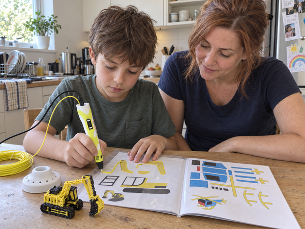 Boy tracing an excavator from the project book